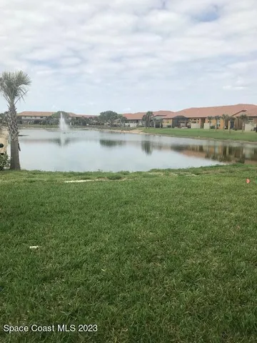a view of a lake with houses in the back