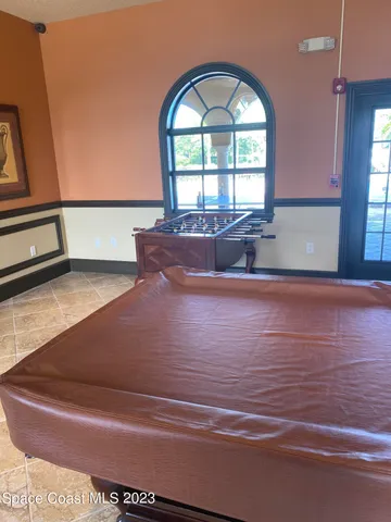 a view of kitchen with cabinets and window