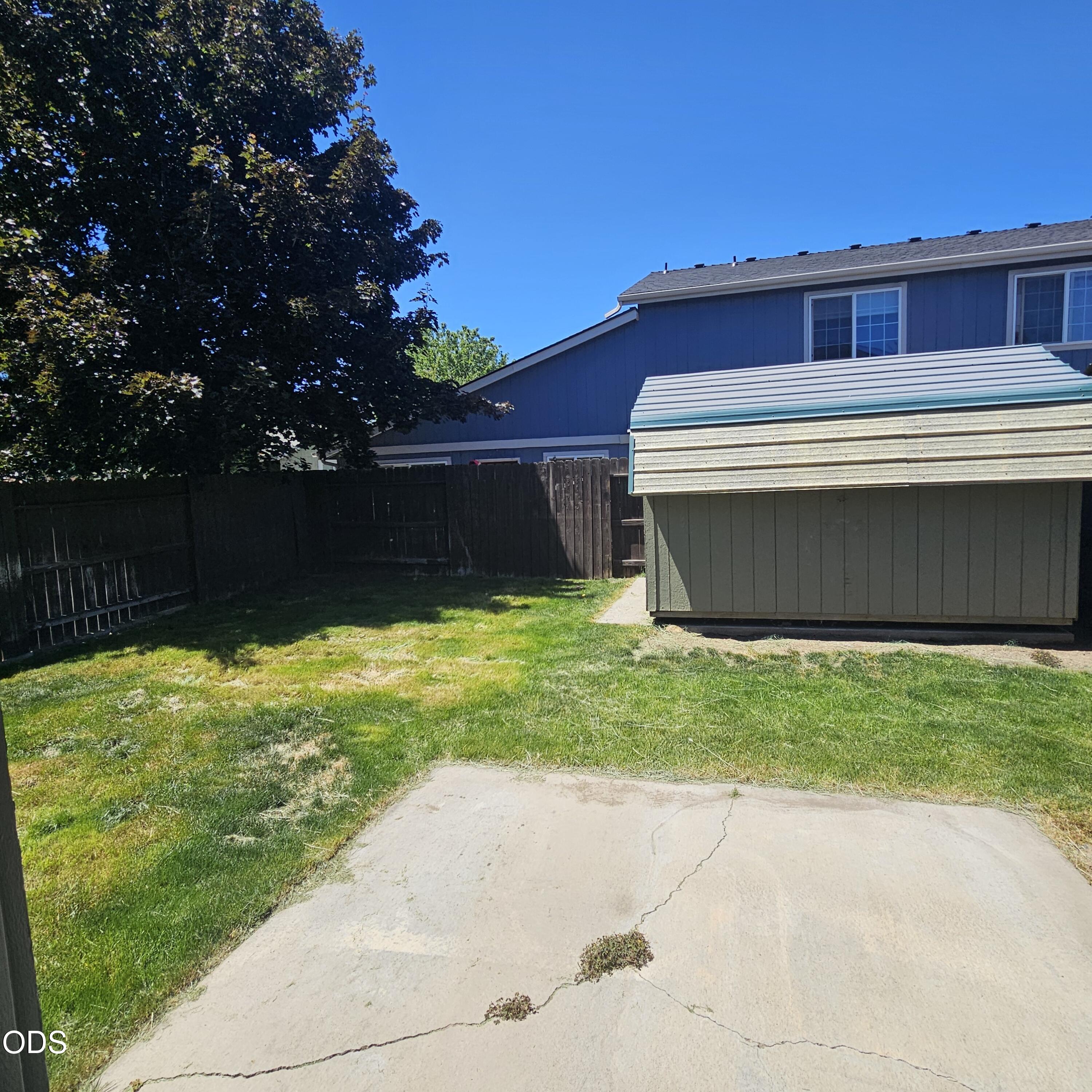 569 Northeast Negus Loop Redmond, OR 97756 - Photo 20 of 32 a view of a backyard with a large tree