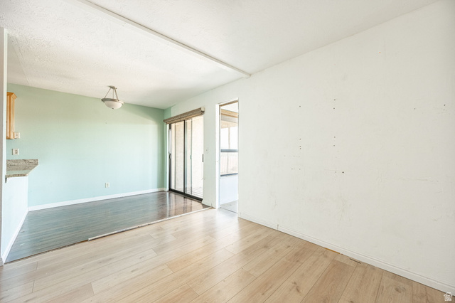 161 West 950 South, Unit C5 St. George, UT 84770 - Photo 6 of 14 Open concept living area featuring light wood-finish flooring, a wall with light blue paint, and a sliding glass door