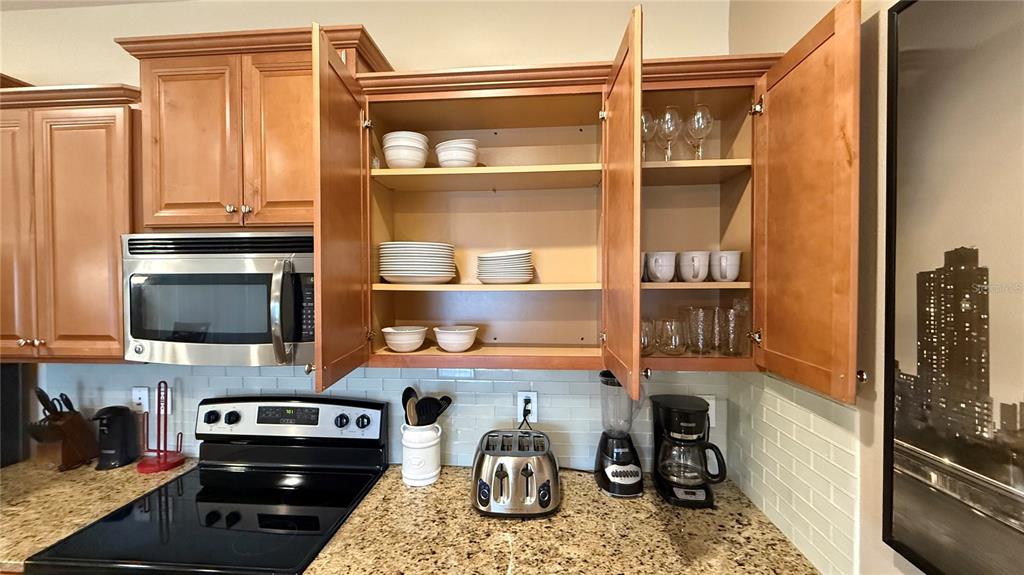 4794 Clock Tower Drive Kissimmee, FL 34746 - Photo 11 of 63 a kitchen with a refrigerator and a stove top oven