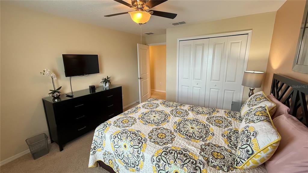 4794 Clock Tower Drive Kissimmee, FL 34746 - Photo 27 of 63 a bedroom with a bed and a flat screen tv