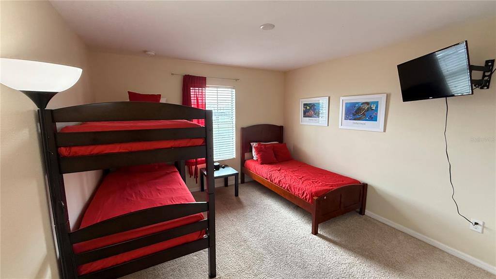 4794 Clock Tower Drive Kissimmee, FL 34746 - Photo 31 of 63 a living room with furniture and a flat screen tv