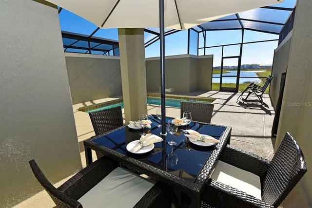 a view of a house with backyard porch and sitting area