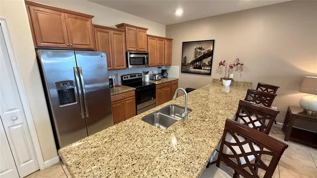 a living room with furniture kitchen view and a flat screen tv