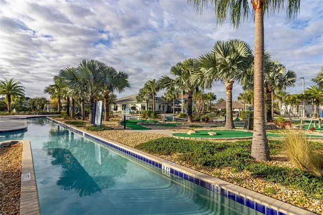 a view of swimming pool with outdoor seating and plants