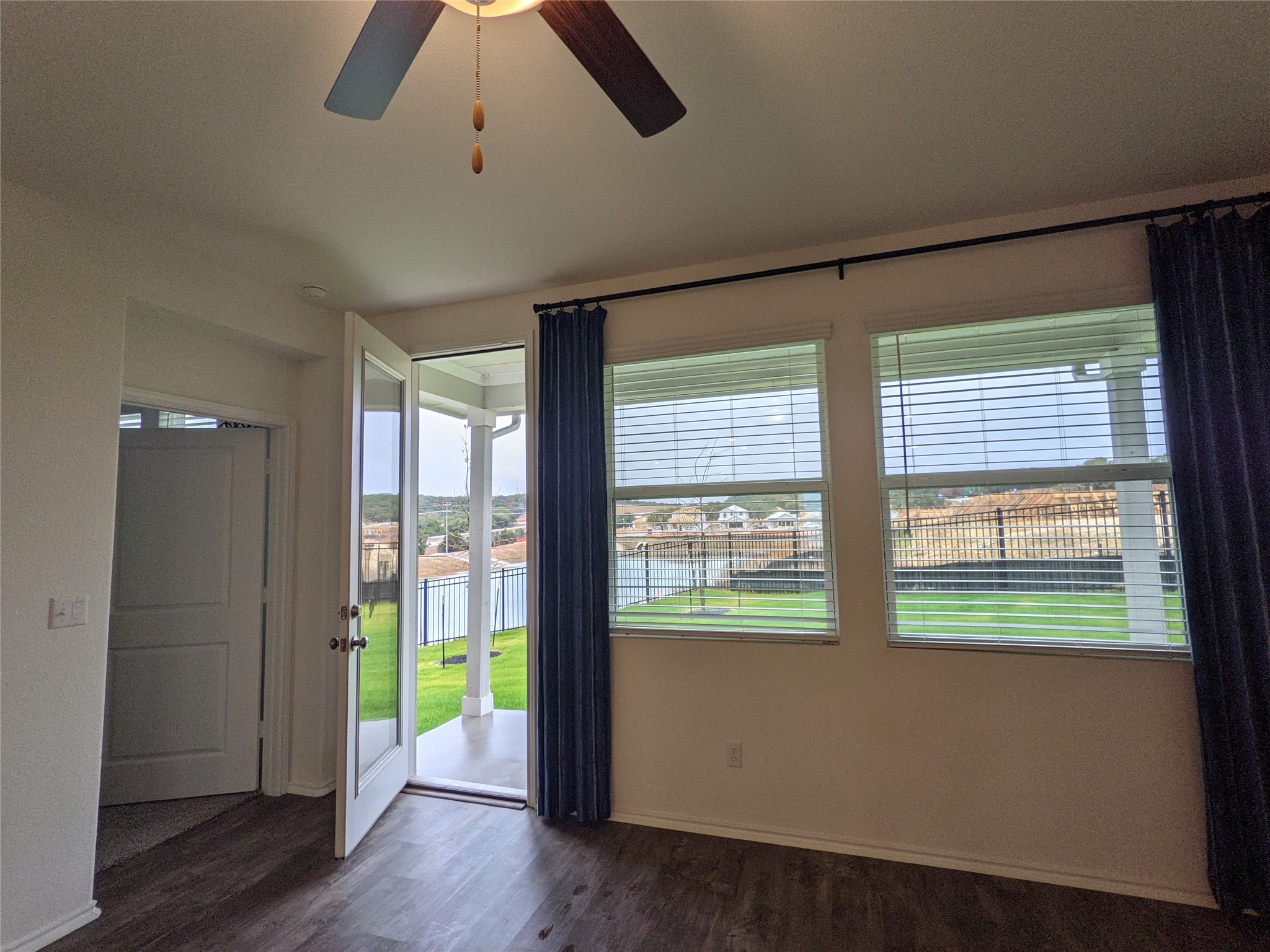 100 Montauk Loop Georgetown, TX 78628 - Photo 19 of 21 Luminous living area featuring a ceiling fan, durable laminate flooring, and direct patio access.