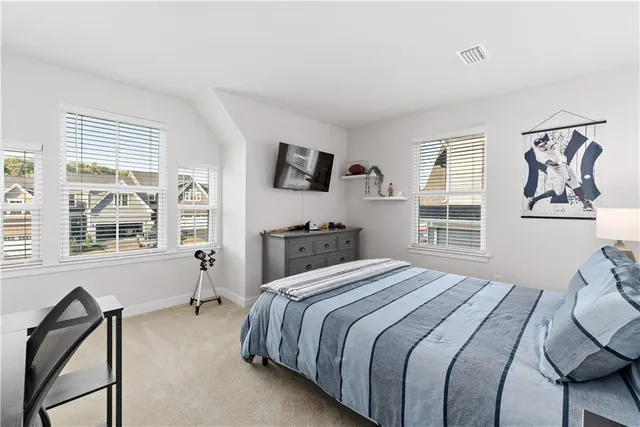 a bedroom with a bed and a television