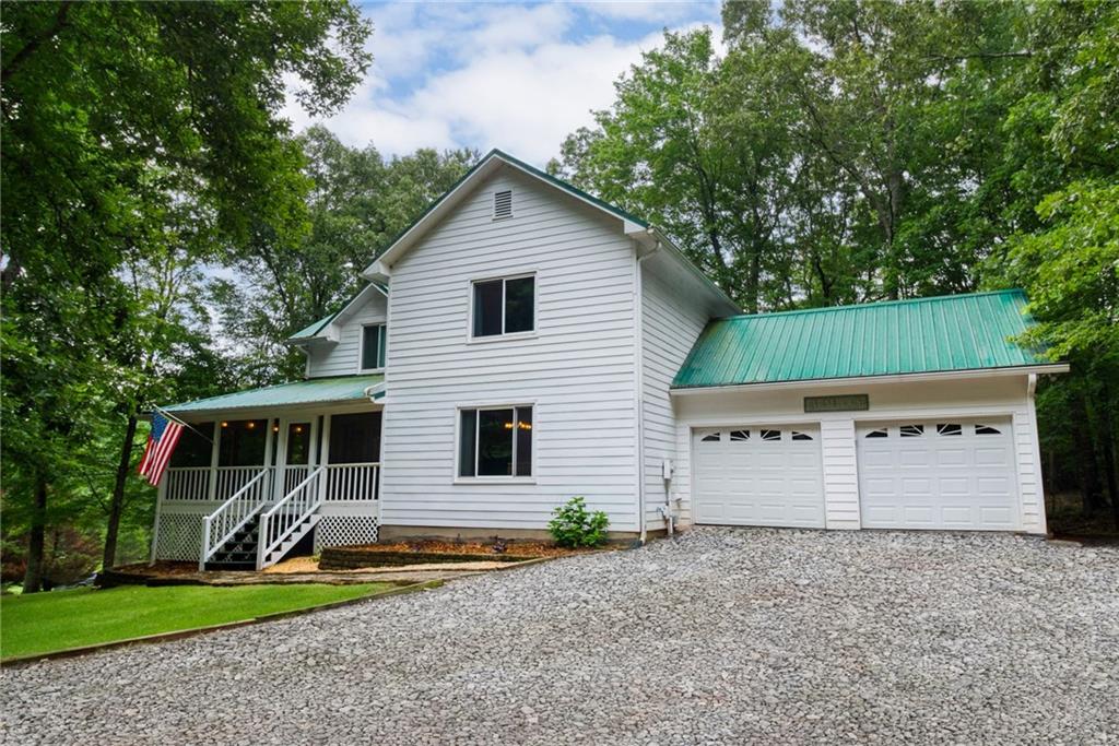 623 Camp Branch Road Ellijay, GA 30540 - Photo 1 of 1 a backyard of a house with potted plants and large tree