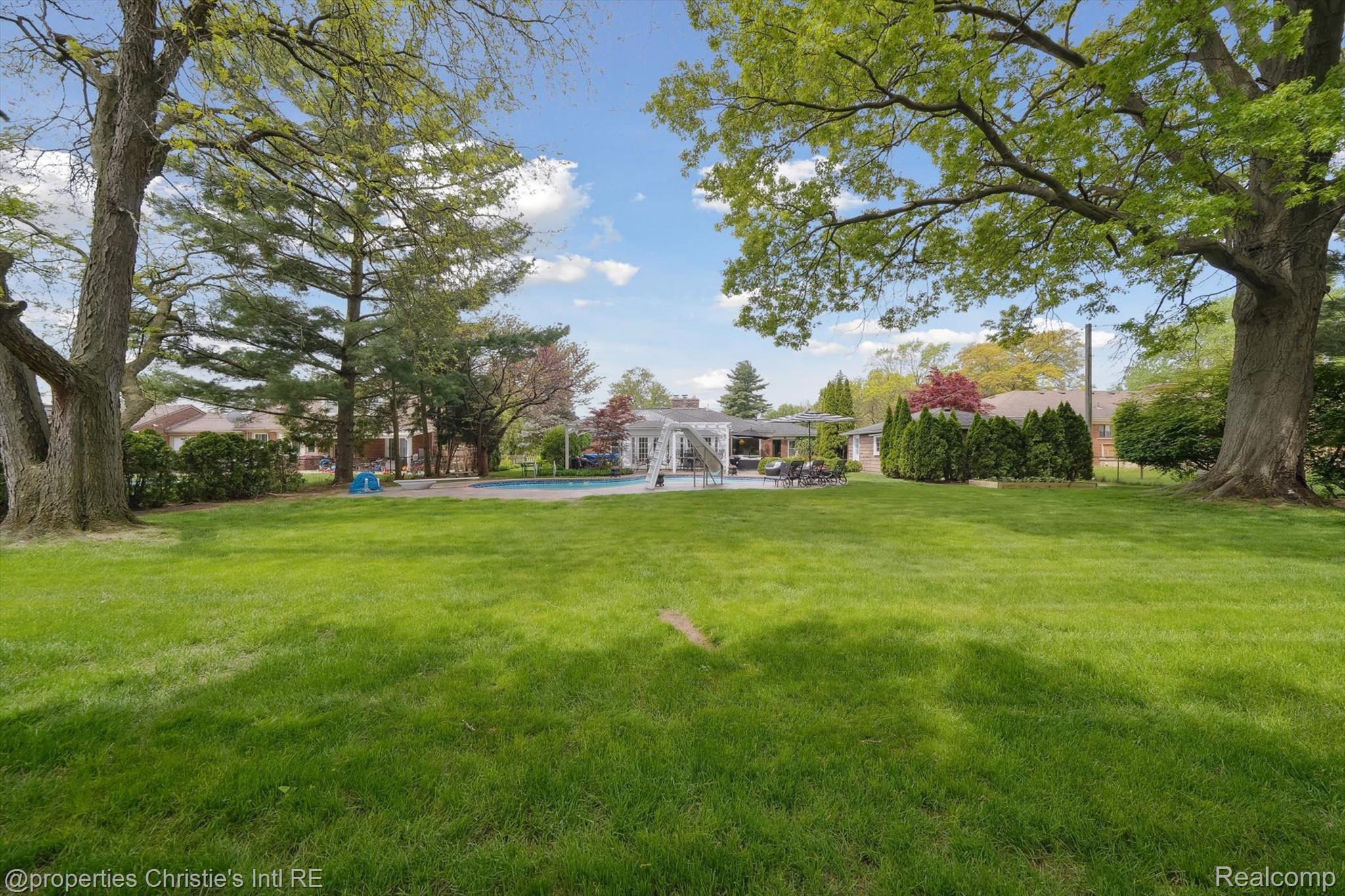 511 South Gulley Road Dearborn, MI 48124 - Photo 37 of 43 Expansive lawn area, mature trees, built-in swimming pool, paved patio, and a pergola