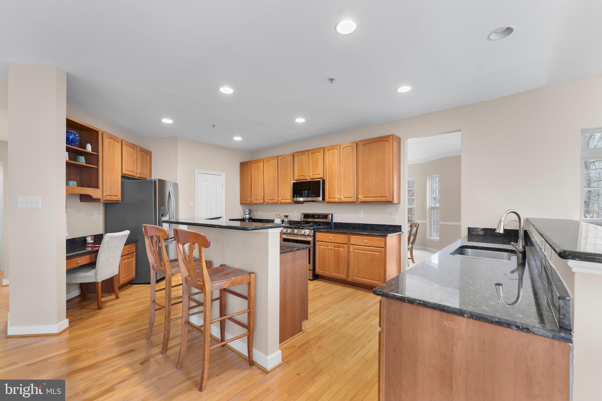 934 Zenith Drive Freeland, MD 21053 - Photo 13 of 50 a kitchen with stainless steel appliances granite countertop a sink counter space and a stove top oven