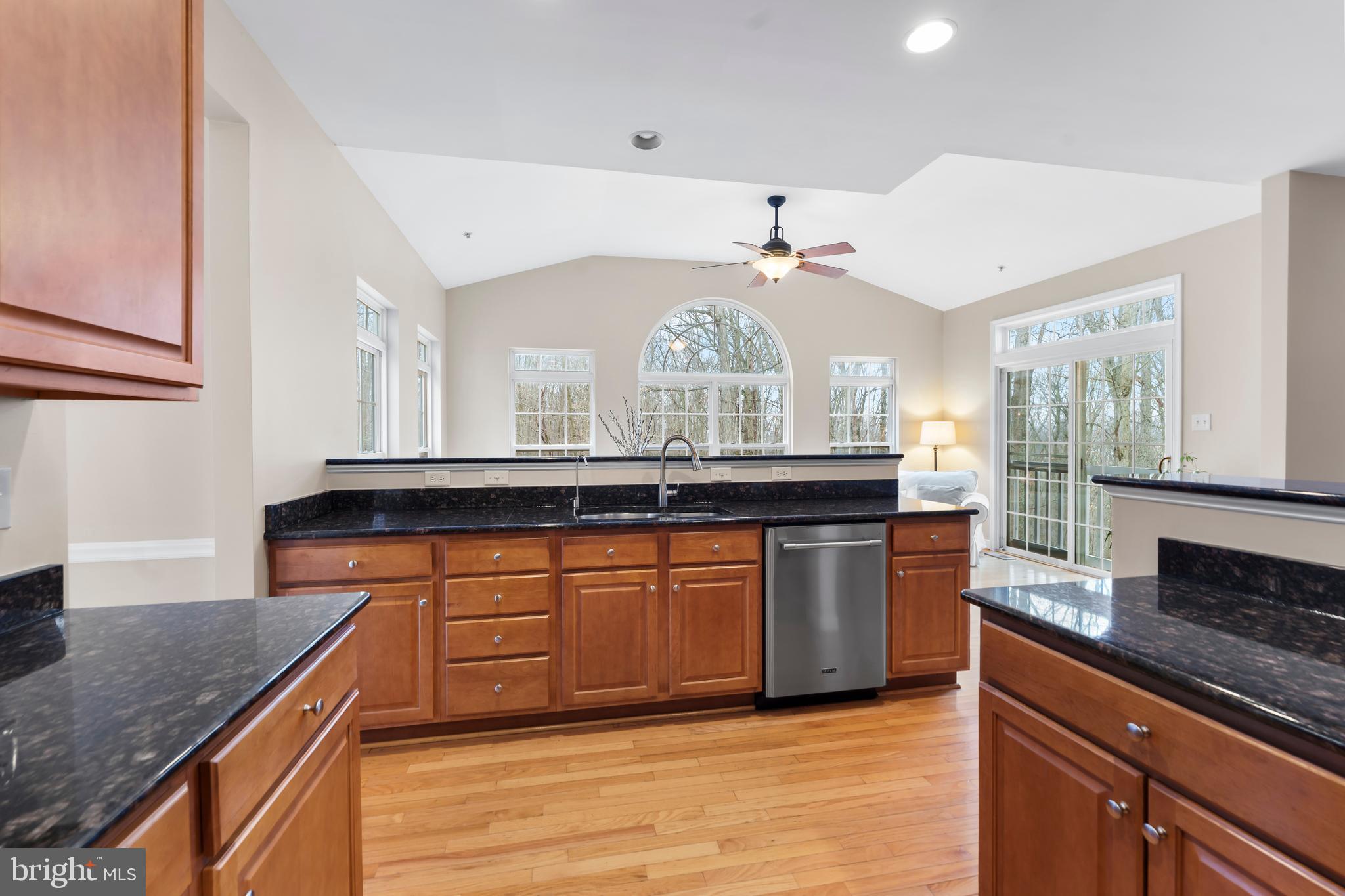 934 Zenith Drive Freeland, MD 21053 - Photo 16 of 50 a kitchen with stainless steel appliances granite countertop a sink a stove and a wooden cabinets