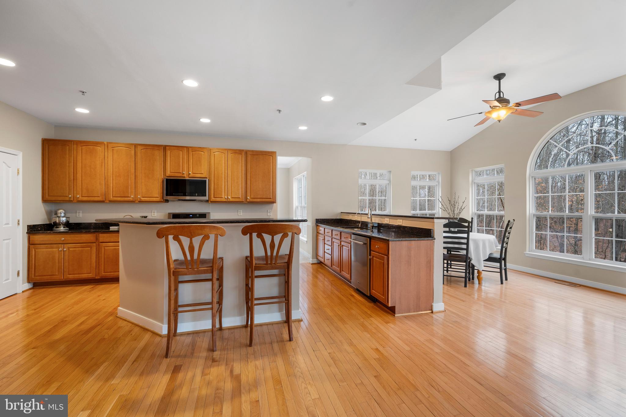 934 Zenith Drive Freeland, MD 21053 - Photo 17 of 50 a kitchen with stainless steel appliances granite countertop a stove top oven a sink a dining table and chairs