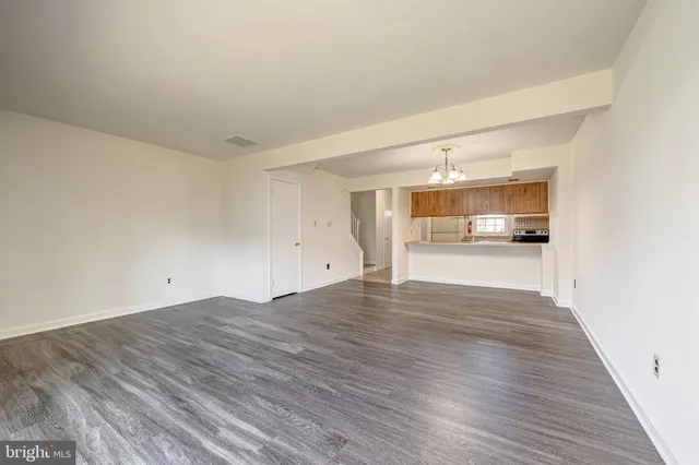 a view of a kitchen with wooden floor and a sink