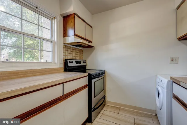 a kitchen with a stove and a window