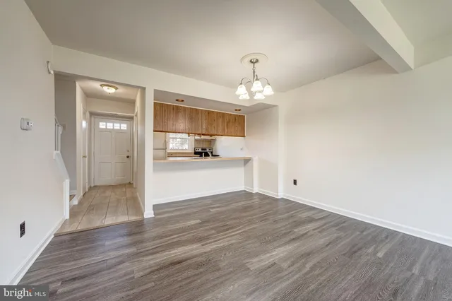 a view of a kitchen with a sink and wooden floor