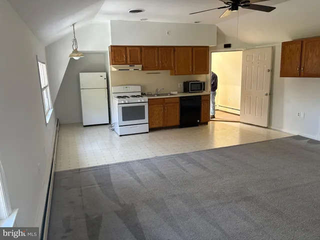 a kitchen with stainless steel appliances a refrigerator and a stove top oven