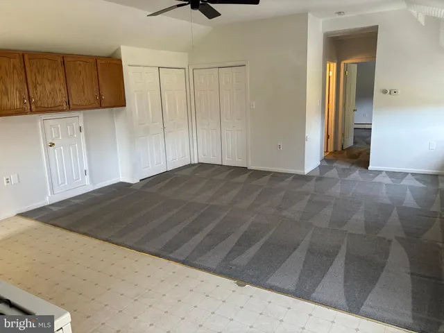 a view of a livingroom with wooden floor and cabinet