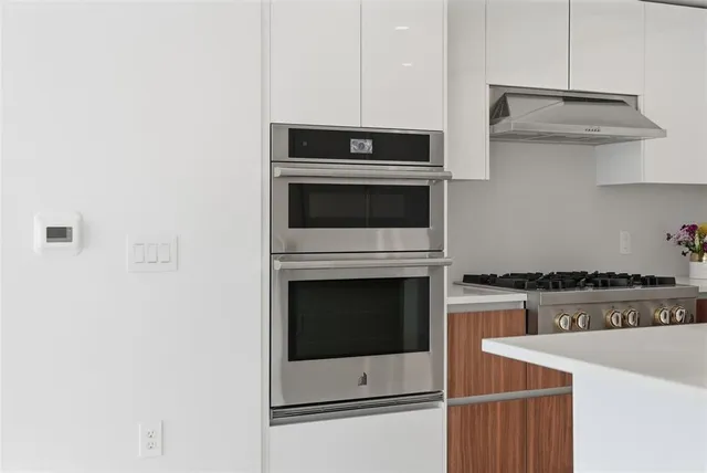 a kitchen with cabinets and stainless steel appliances