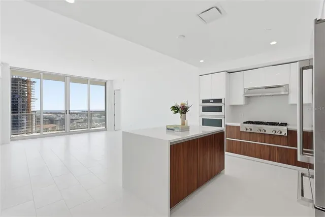 a kitchen with stainless steel appliances granite countertop a stove and a refrigerator