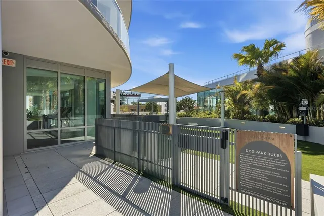 a living room with furniture and large windows
