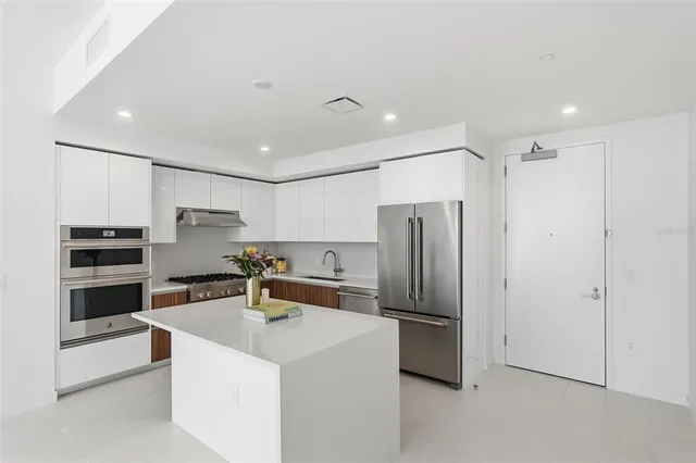 a kitchen with stainless steel appliances a refrigerator and a sink