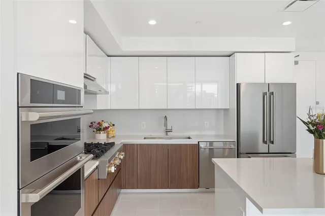 a kitchen with a sink stainless steel appliances and cabinets