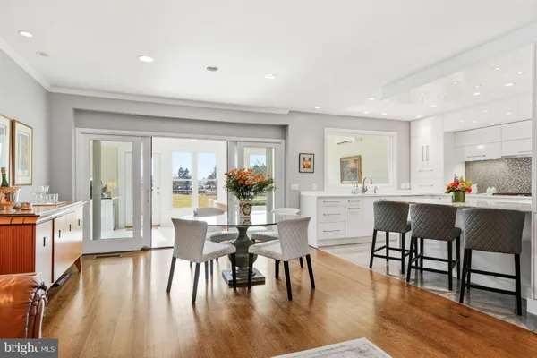 a bedroom with a bed couch and wooden floor
