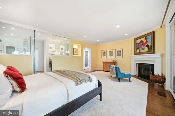 a bedroom with a bed and a refrigerator