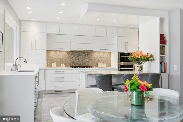 a view of a dining room with furniture a fireplace and wooden floor