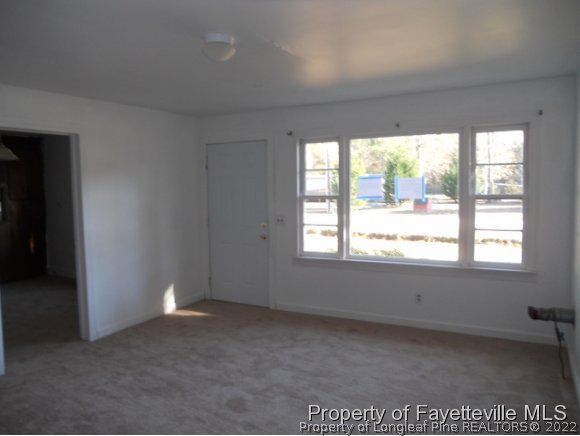 201 Thornton Road Dunn, NC 28334 - Photo 2 of 6 an empty room with a window