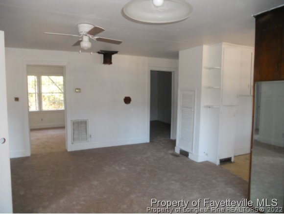 201 Thornton Road Dunn, NC 28334 - Photo 3 of 6 an empty room with windows and closet