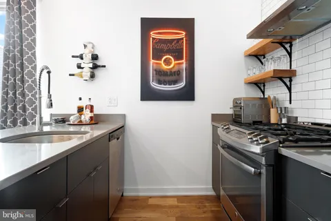 a kitchen with stainless steel appliances granite countertop a stove and a sink