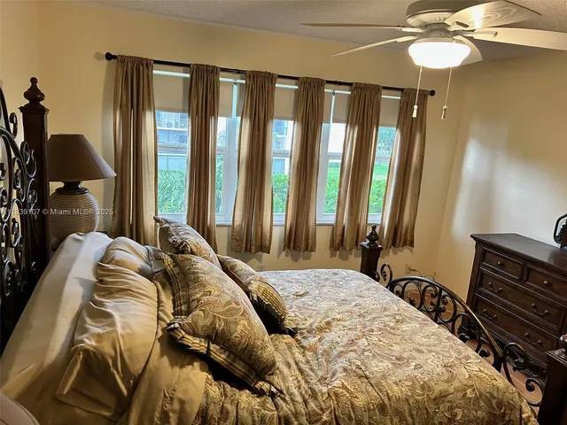 a bedroom with a bed and a mirror on dresser