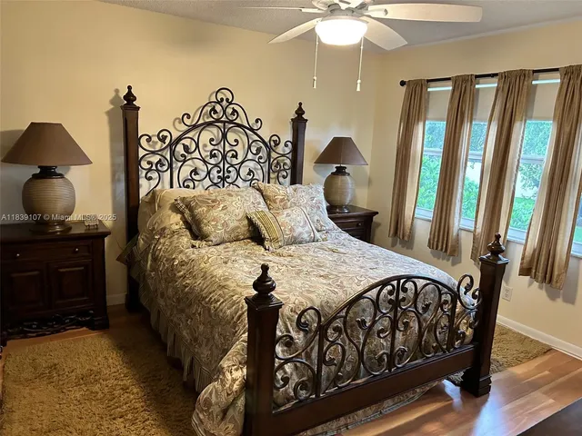 a bedroom with a bed and a mirror on dresser