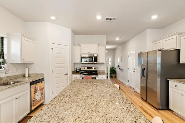 a living room with furniture a chandelier and a flat screen tv