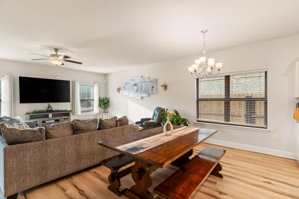 a living room with kitchen island furniture and a chandelier