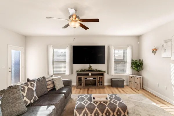 a living room with furniture and a flat screen tv