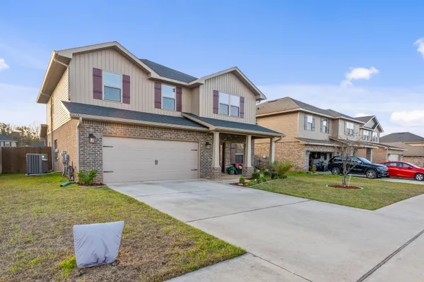 a front view of a house with a yard and garage