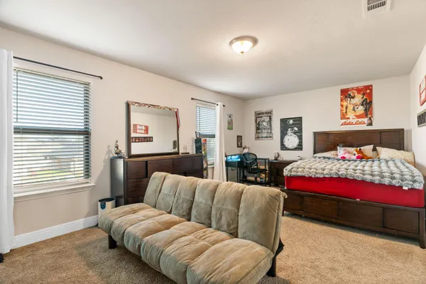 a bedroom with furniture and a bed