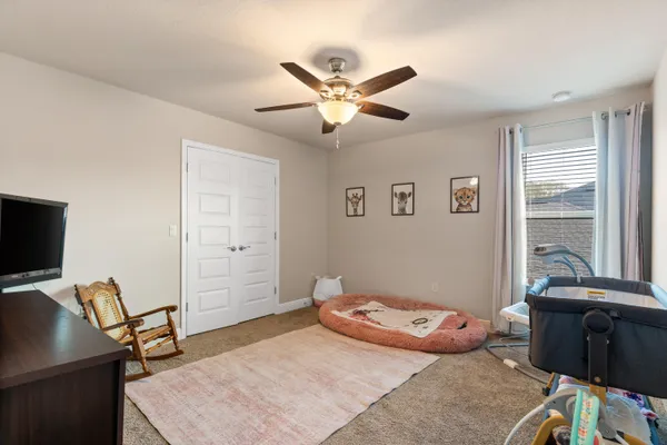 a bedroom with a bed and a chair