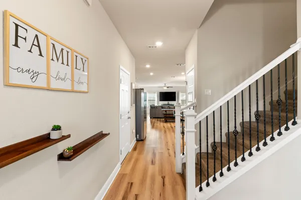 a hallway with dining room and wooden floor