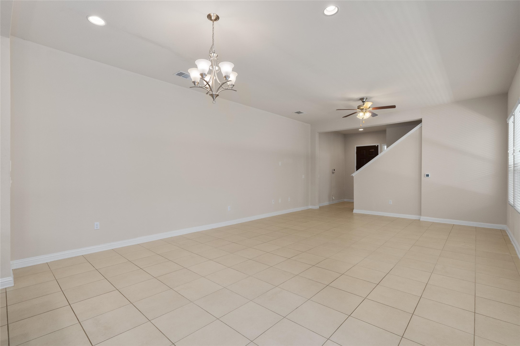 6907 Idea Road Austin, TX 78741 - Photo 4 of 36 a view of an empty room with chandelier fan