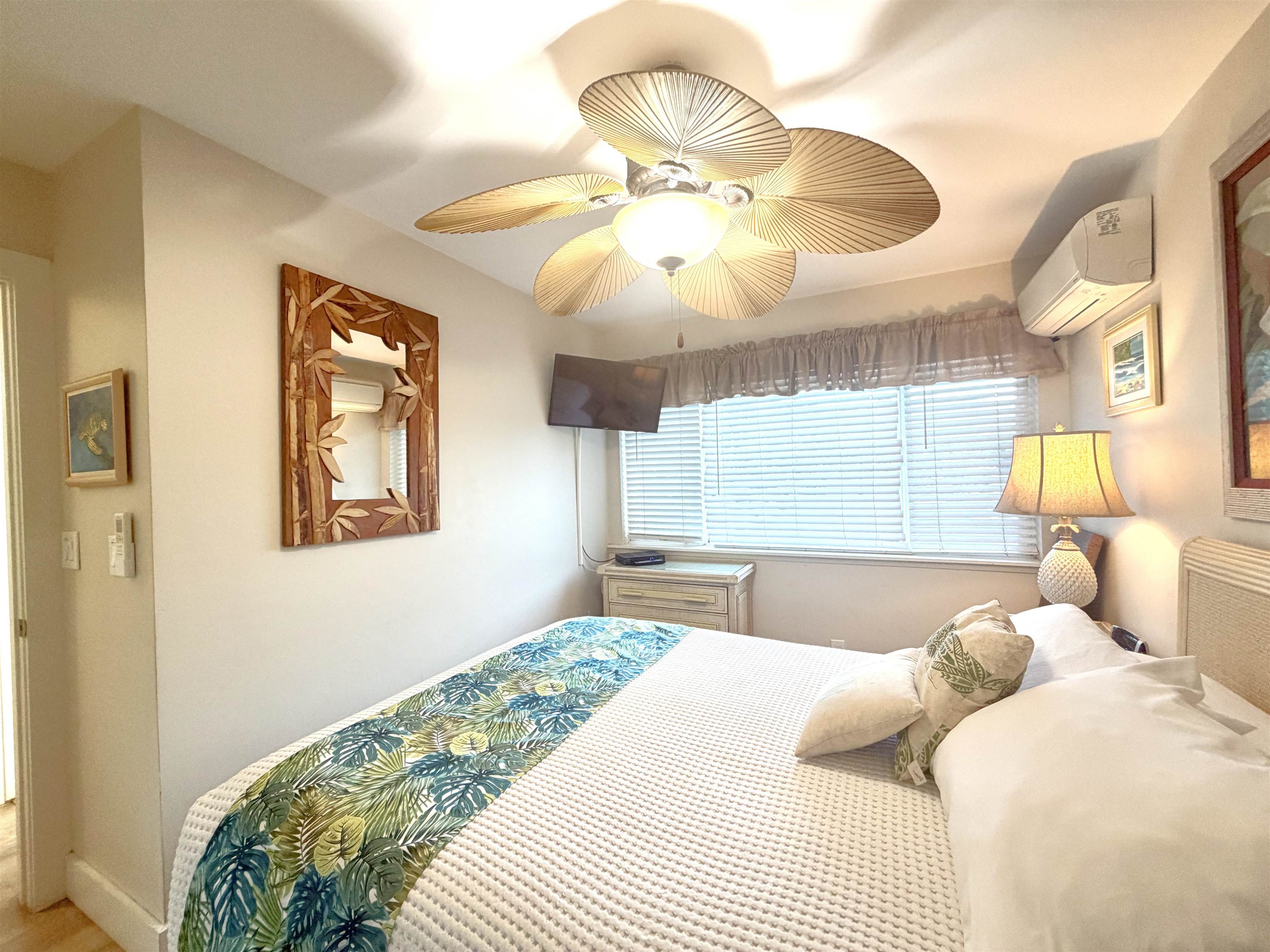 61 North Kihei Road, Unit 18 Kihei, HI 96753 - Photo 11 of 23 a bedroom with a bed and a chandelier
