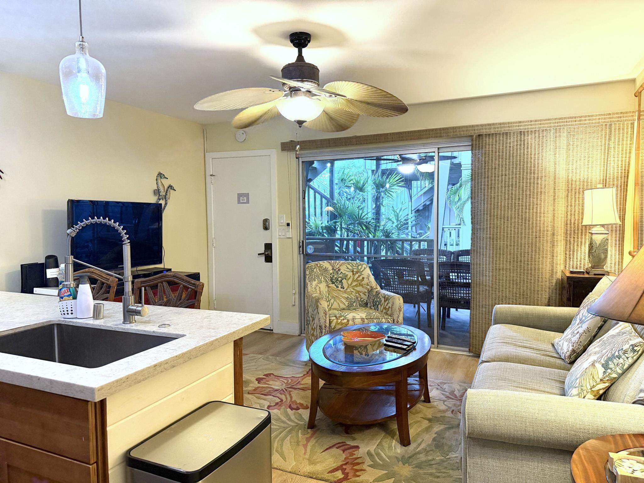 61 North Kihei Road, Unit 18 Kihei, HI 96753 - Photo 15 of 23 a living room with furniture and a chandelier