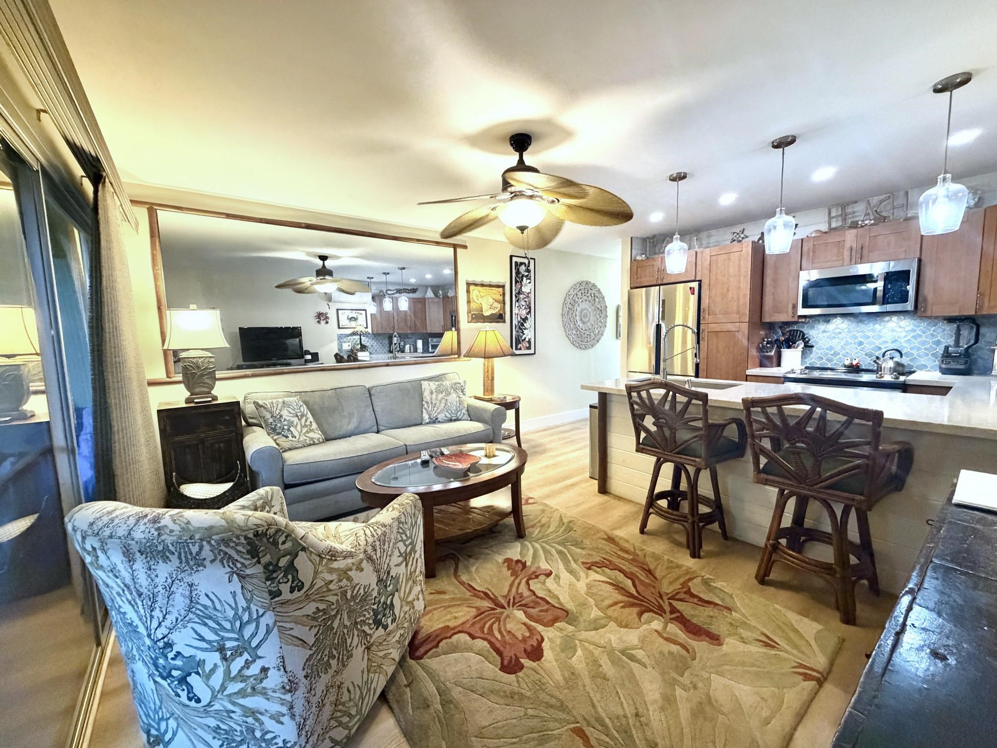 61 North Kihei Road, Unit 18 Kihei, HI 96753 - Photo 16 of 23 a living room with fireplace furniture and a chandelier