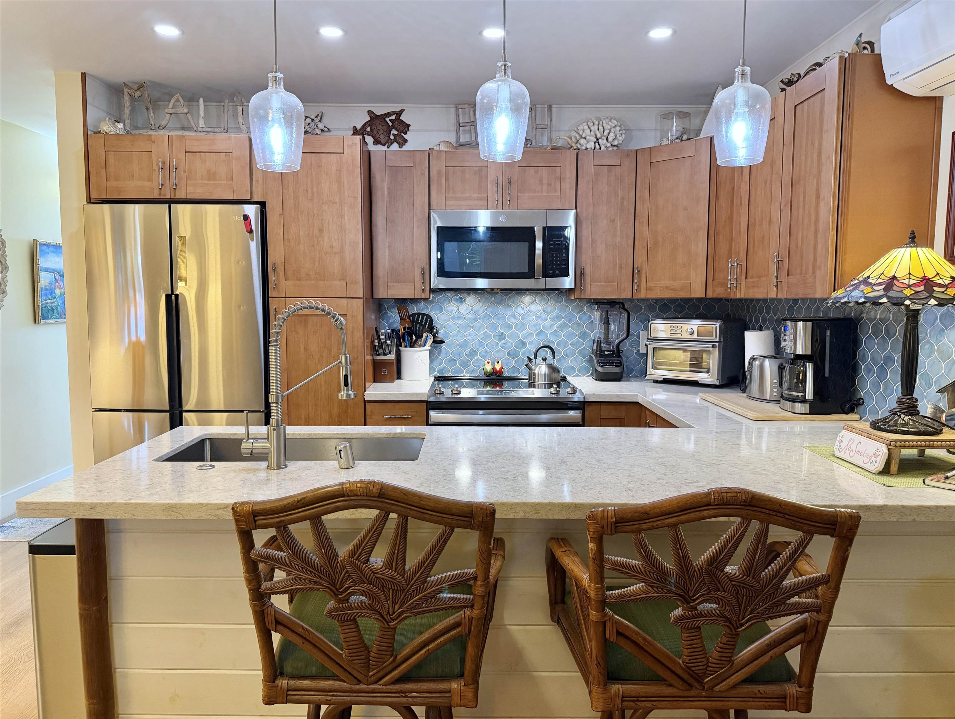 61 North Kihei Road, Unit 18 Kihei, HI 96753 - Photo 5 of 23 a kitchen with stainless steel appliances granite countertop a sink refrigerator and cabinets