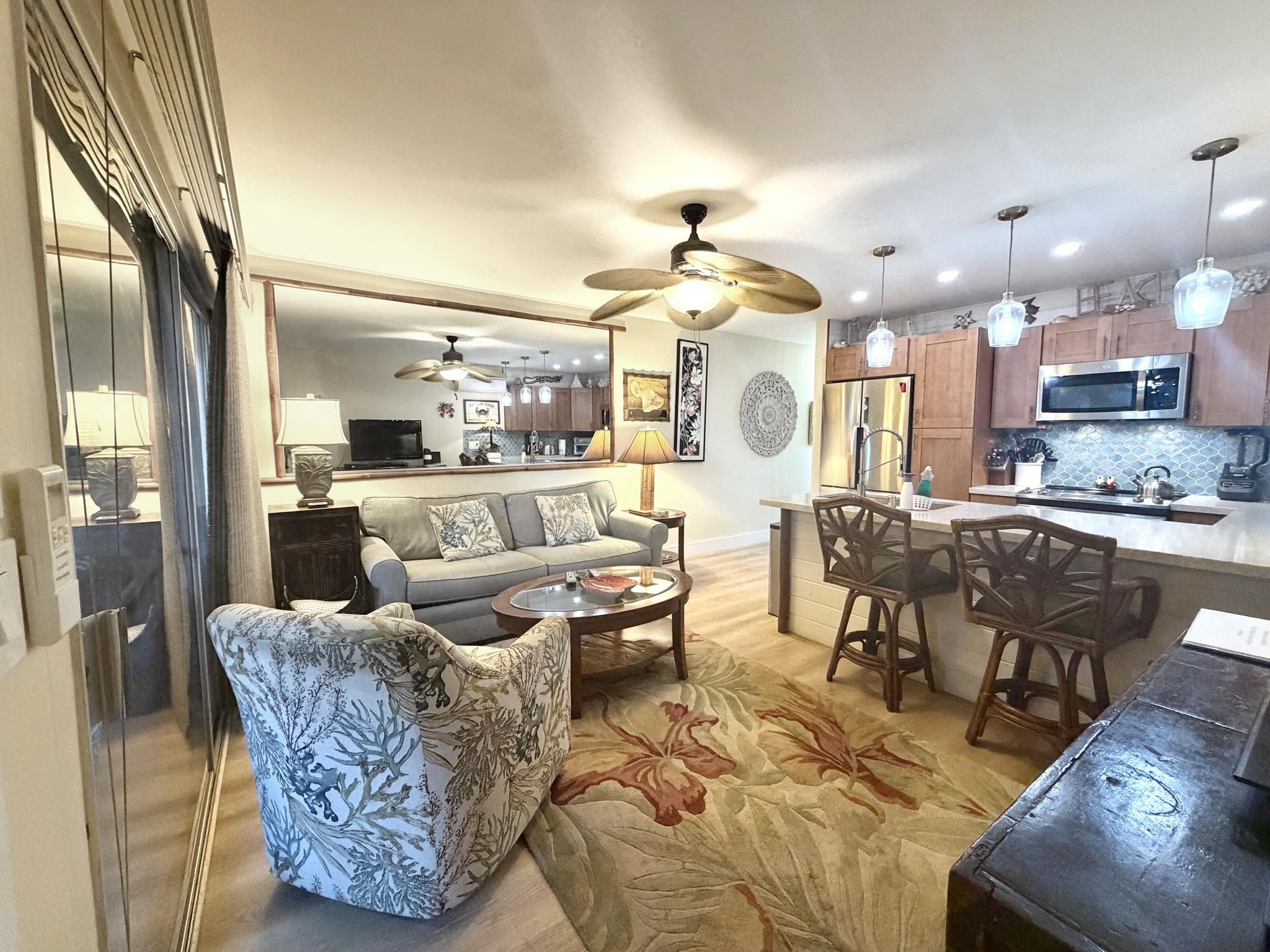 61 North Kihei Road, Unit 18 Kihei, HI 96753 - Photo 7 of 23 a living room with couches and kitchen view with kitchen view