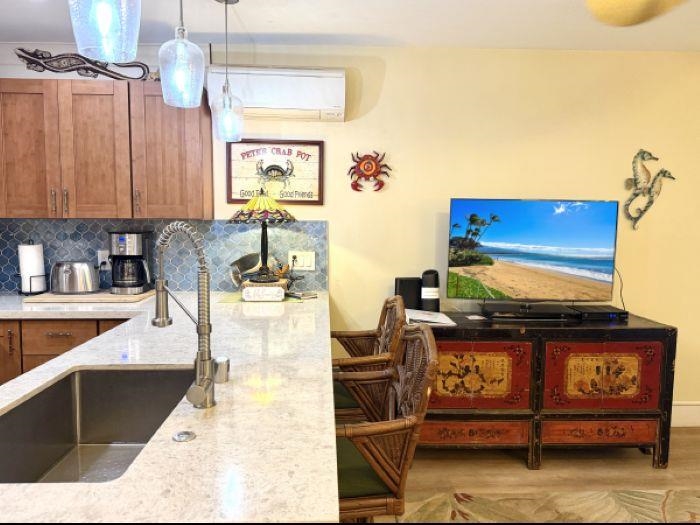 61 North Kihei Road, Unit 18 Kihei, HI 96753 - Photo 8 of 23 a kitchen with a stove and a table