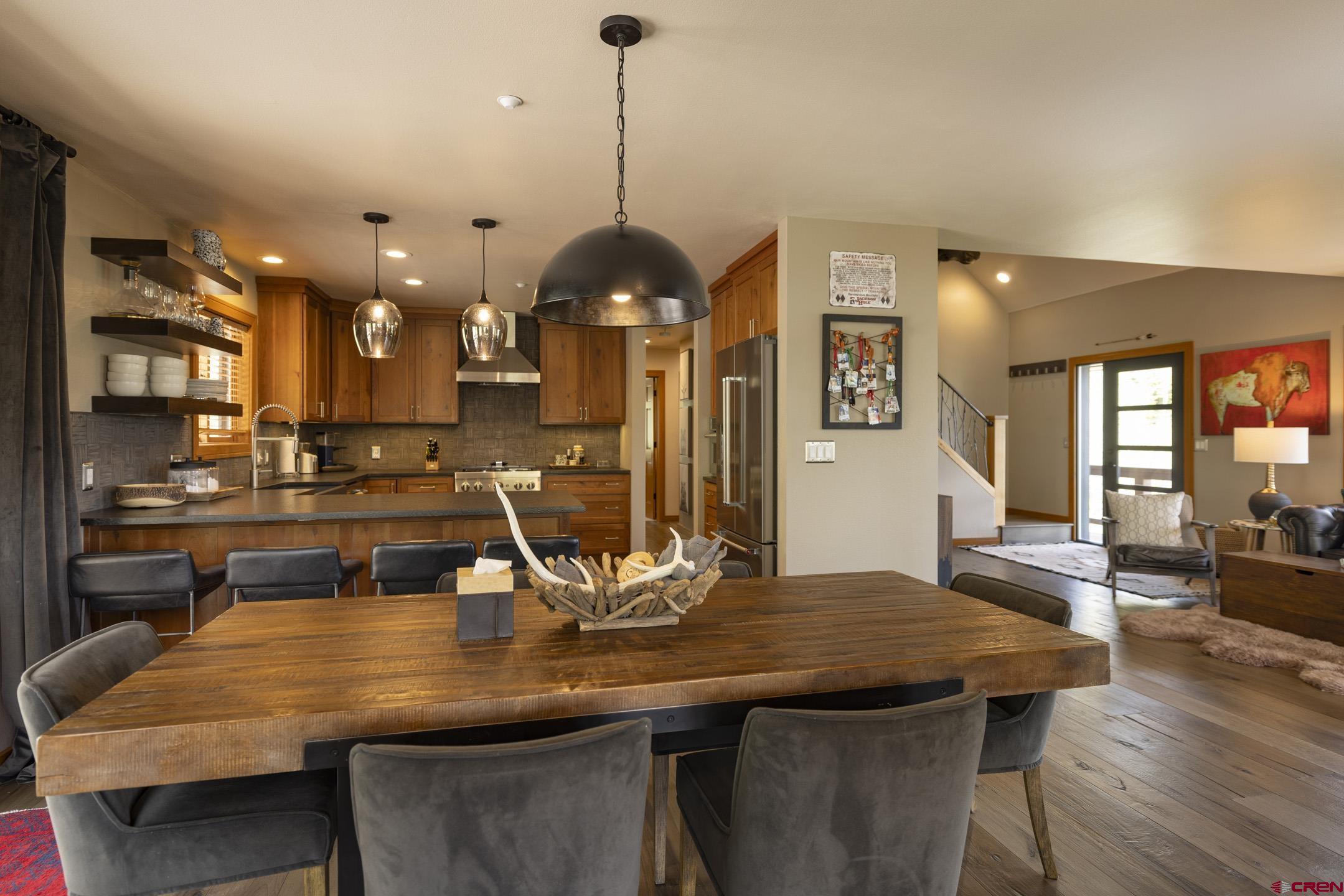 154 Falcon Ridge Road Durango, CO 81301 - Photo 15 of 42 a kitchen with a table and chairs in it